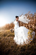 Young beautiful bride posing in field Young beautiful bride posing in field