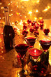 Photo: Closeup of red wine and candle lights. Closeup of red wine and candle lights.