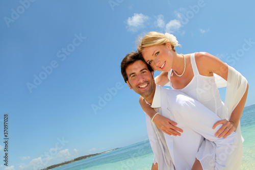 Photo: Groom holding bride on his back Groom holding bride on his back
