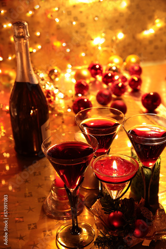 Photo: Closeup of red wine and candle lights. Closeup of red wine and candle lights.