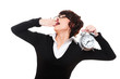 drowsy businesswoman holding alarm clock drowsy businesswoman holding alarm clock