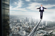 Business man balancing on the rope