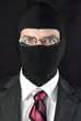 Businessman In Balaclava Looks At Camera