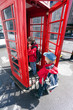 Boy talking in pay phone box
