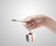Hand holding key with a keychain in the shape of the gift box