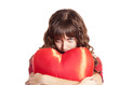 Sad brunette girl with toy heart. Photo for st. Valentine post c