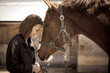 Portrait of smiling young woman with horse