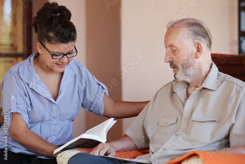 Photo: carer reading to senior carer reading to senior