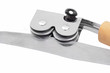 Image : Sharpening a knife with a knife grinder on white background