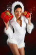 Young sexy woman in Christmas costume holding gift boxes