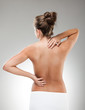 Woman massaging pain back Woman massaging pain back