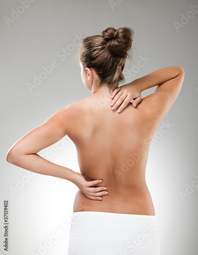 Photo: Woman massaging pain back Woman massaging pain back