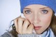 A woman crying, wiping her tears away with a tissue