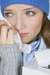 A woman crying, wiping her tears away with a tissue