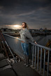 Young girl posing at sunset on bridge