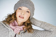 Portrait of a young woman wearing a grey woollen hat
