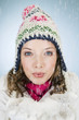 A young woman holding a handful of snow