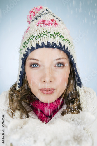 Photo: A young woman holding a handful of snow A young woman holding a handful of snow