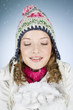 A young woman holding a handful of snow