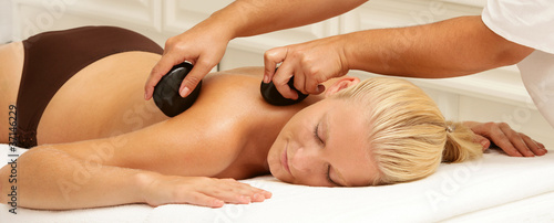 Photo: woman getting hot stone massage woman getting hot stone massage