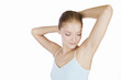 A young woman with her hands behind her head
