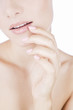 A young woman's face, fingers touching  her mouth