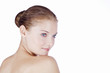 A young woman with blue eyes, looking over her shoulder