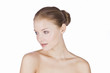 Portrait of a young woman with blue eyes, hair in a bun