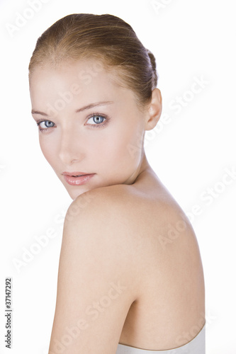Photo: Portrait of a young woman with blue eyes, hair in a bun Portrait of a young woman with blue eyes, hair in a bun