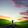 Man walking away at dawn along road