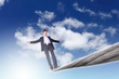 Business man balancing on the rope