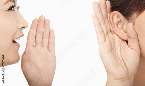 Photo: women talking and listening to gossip women talking and listening to gossip