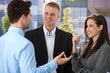 Photo: Young businesspeople talking outside of office Young businesspeople talking outside of office