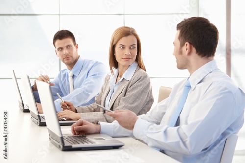 Photo: Young businessteam working together in office Young businessteam working together in office