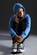 Blonde teenager girl alone and sad in blue hoodie