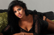 Photo: Beautiful ethnic glamour girl lying on sofa Beautiful ethnic glamour girl lying on sofa
