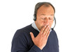 Gähnender Mann mit Headset