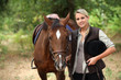 Woman walking horse
