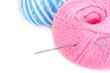 Varicoloured balloons of yarn with knitting needles