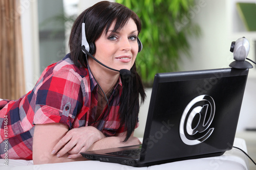 Photo: Woman chatting over the internet Woman chatting over the internet