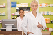 Young pharmacist with thumbs up