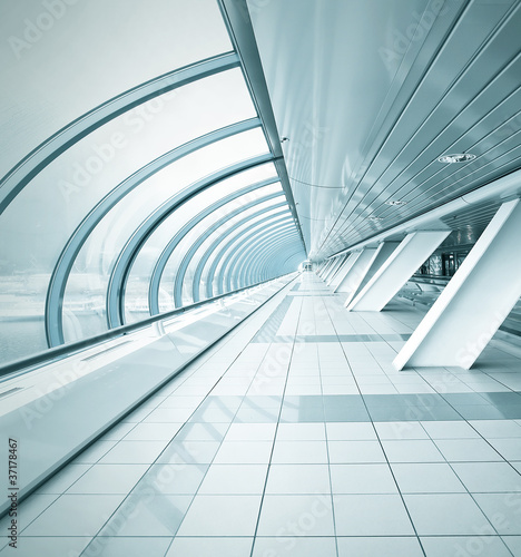 Photo: wide spacious corridor in contemporary airport walkway wide spacious corridor in contemporary airport walkway