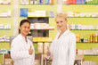 Photo: Young pharmacists with thumbs up Young pharmacists with thumbs up