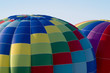 Top sections of hot-air balloons inflating or ascending