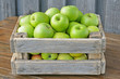 Green apples in a box