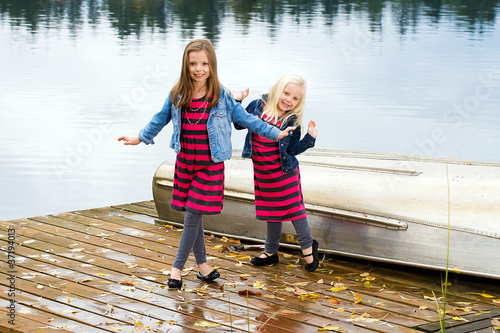 Photo: Two cute kids dancing on a boat dock Two cute kids dancing on a boat dock