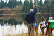 Group of people waving at a train on a lake