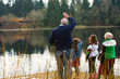 Old man and kids waving at a passing train