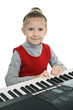 Foto: A girl playing on a digital keyboard A girl playing on a digital keyboard