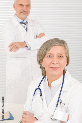 Photo: Medical team doctors by desk work computer Medical team doctors by desk work computer